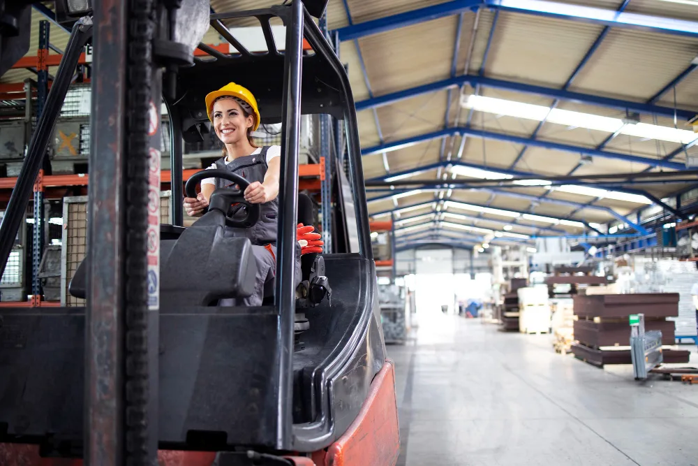 Woman working on forklift
